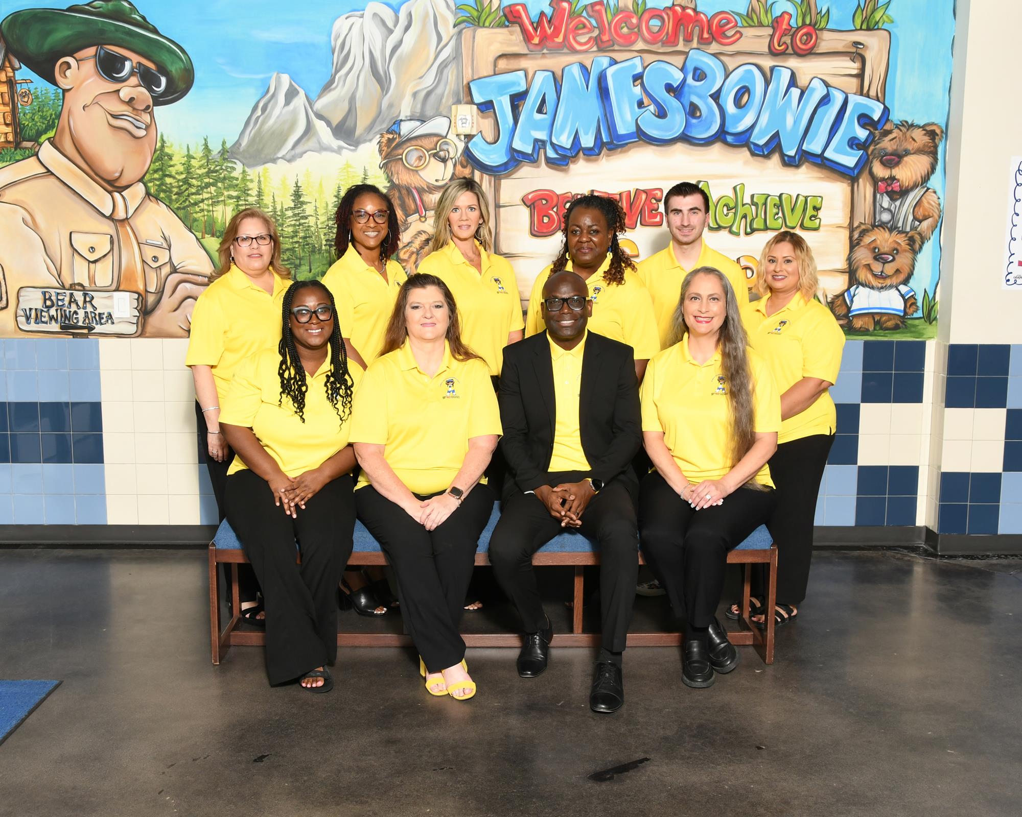 Office staff smiling and posing for a staff picture